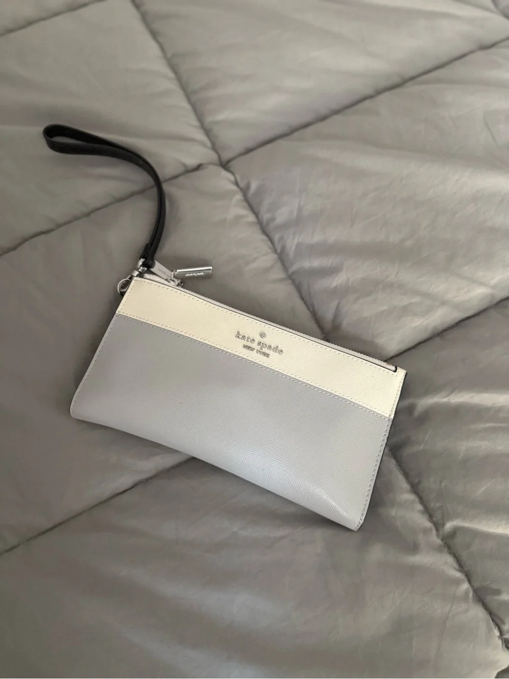kate spade gray and cream wristlet with black strap